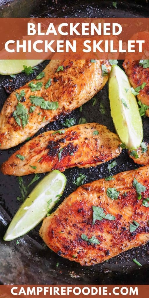 Blackened chicken breast with lime wedges and cilantro.