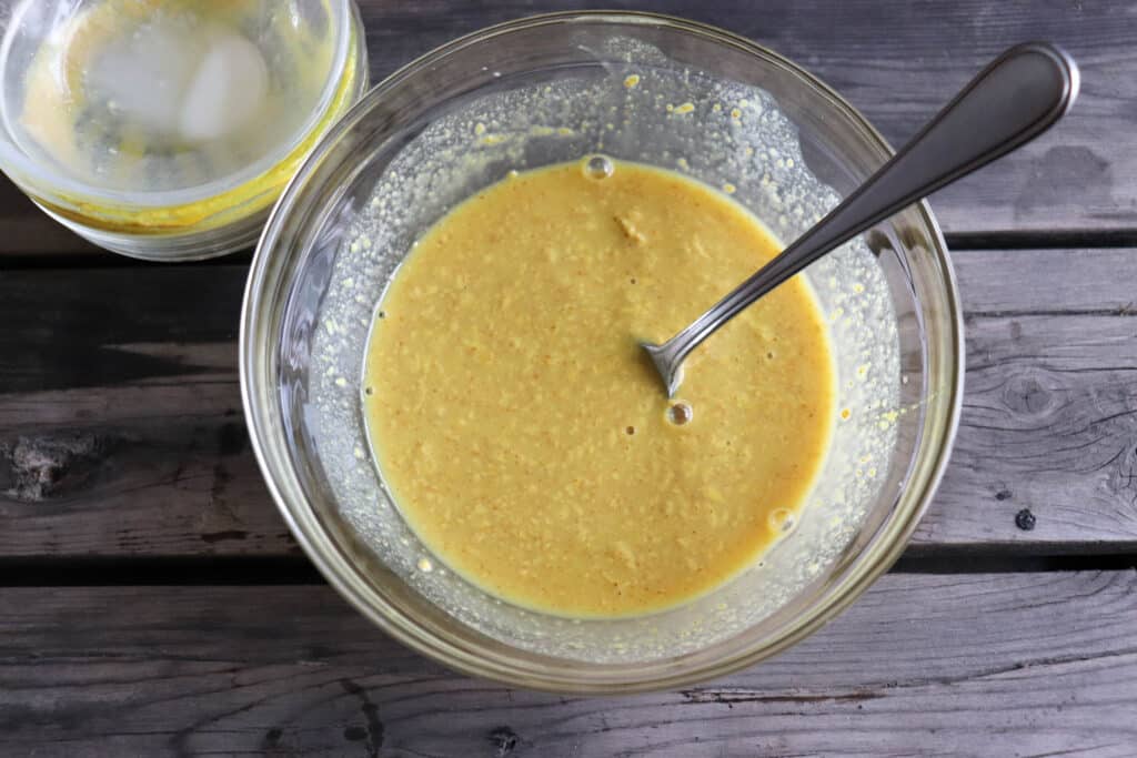 Honey mustard ingredients in a medium clear glass mixing bowl.