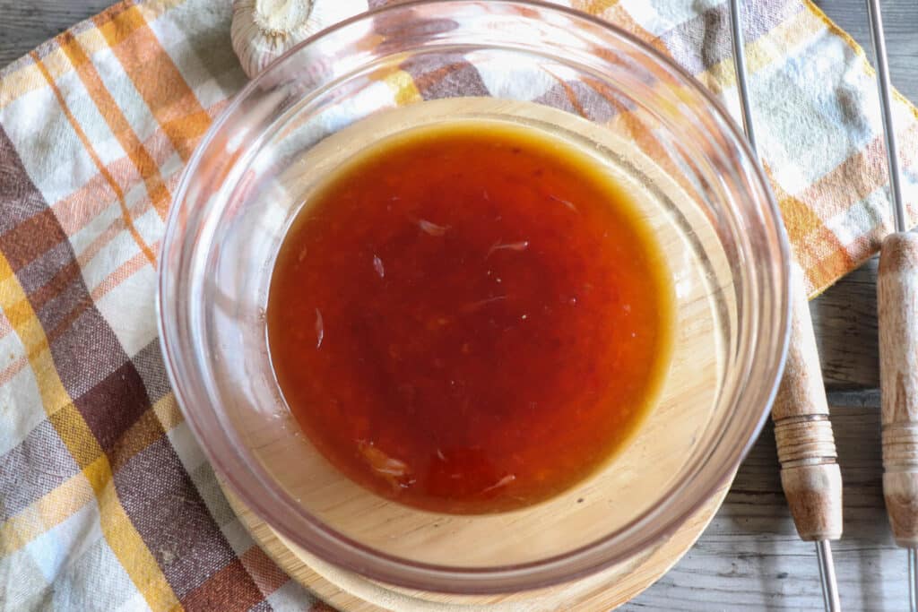 Sweet chili sauce in a medium glass bowl.
