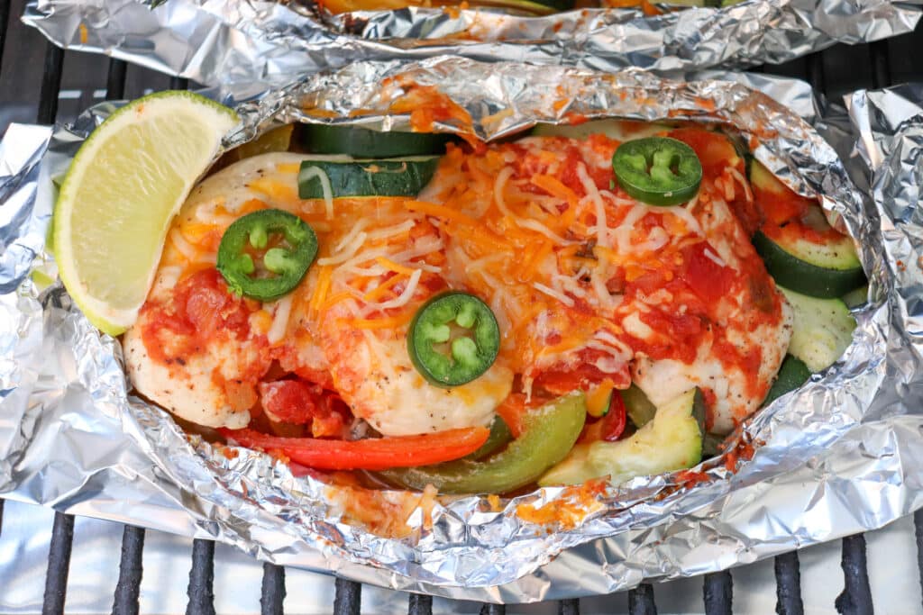 Salsa and chicken and melted cheese in a foil pack on the grill.