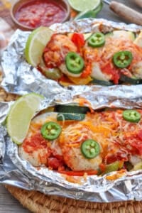 Salsa and cheese over chicken in foil packets.