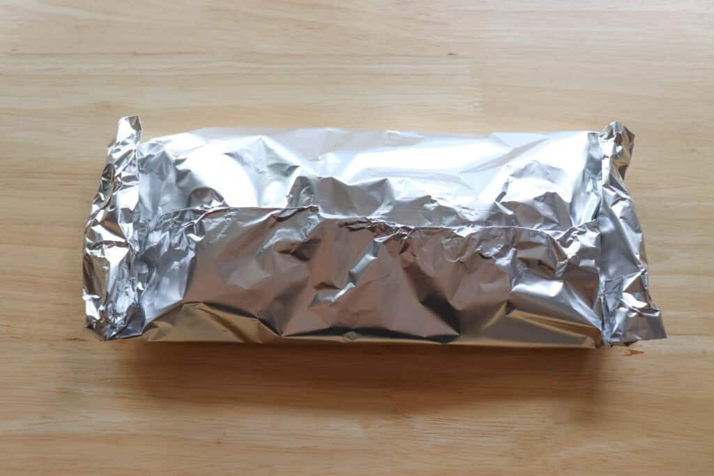 Foil packet on a wooden table.