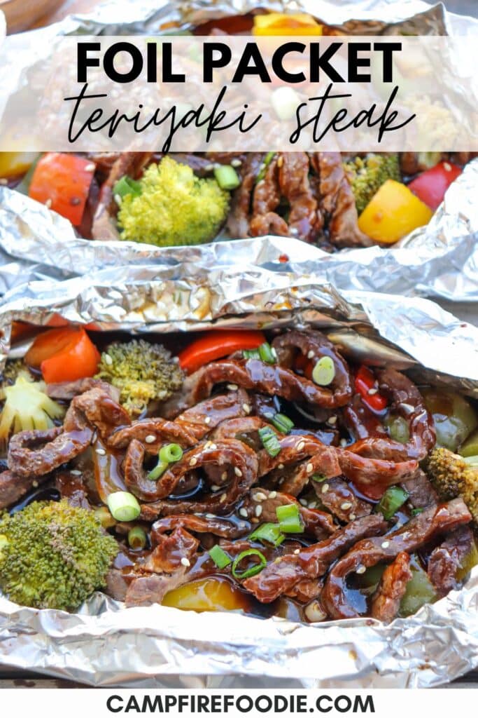 Grilled teriyaki steak with broccoli, bell peppers, and green onions in foil packets. The vibrant dish is garnished with sesame seeds and set on a rustic surface. Text above reads Foil Packet Teriyaki Steak and campfirefoodie.com at the bottom.