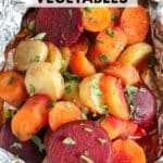 A foil packet filled with sliced roasted vegetables, including carrots, beets, and potatoes, garnished with chopped parsley. Text overlay reads foil packet vegetables and campfirefoodie.com.