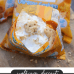 An opened bag of Bear Cub Grahams filled with pumpkin pie mix and whipped cream, topped with bear-shaped graham crackers. Text below reads: walking dessert - Pumpkin Pie - campfirefoodie.com.