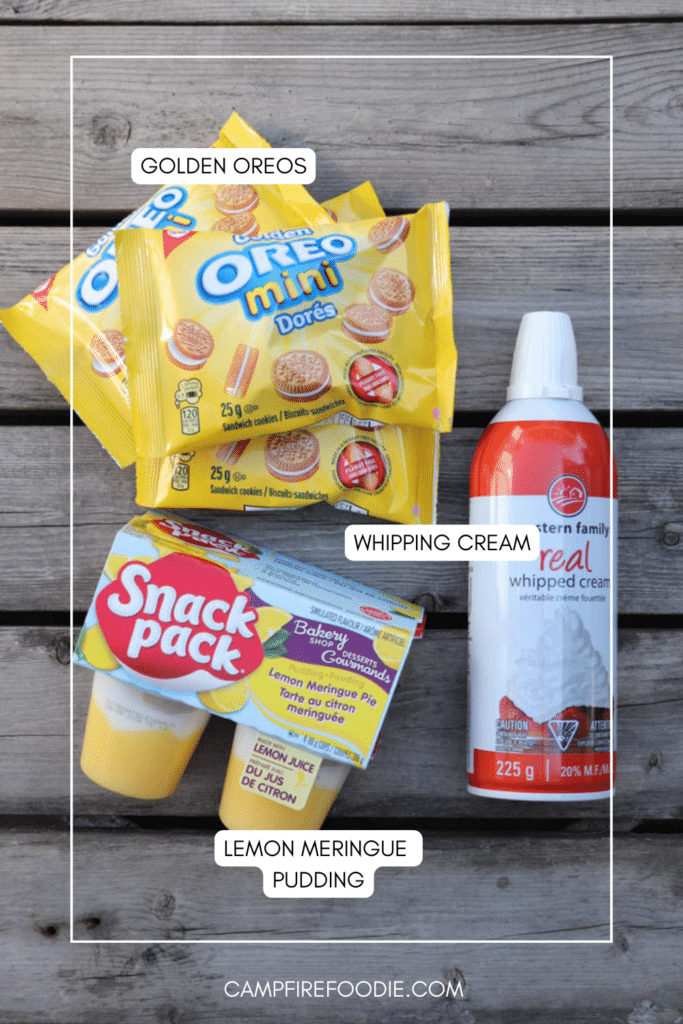 Three packs of Golden Oreo Mini cookies, a can of whipped cream, and a lemon meringue pudding cup on a wooden surface, each item labeled with white text boxes.