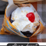 A small open chip bag filled with cherry pie filling, topped with whipped cream and a cherry, with a white plastic spoon inside. Text reads: walking dessert CHERRY PIE campfirefoodie.com.