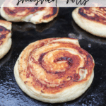Close-up of golden-brown swirl rolls cooking on a Blackstone griddle. Text on the image reads: BLACKSTONE smashed rolls with campfirefoodie.com at the bottom.