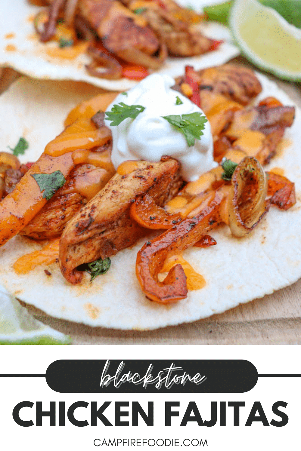 Close-up of chicken fajitas on tortillas, topped with sautéed peppers, onions, melted cheese, a dollop of sour cream, and cilantro, with lime slices on the side. Text reads: blackstone chicken fajitas campfirefoodie.com.